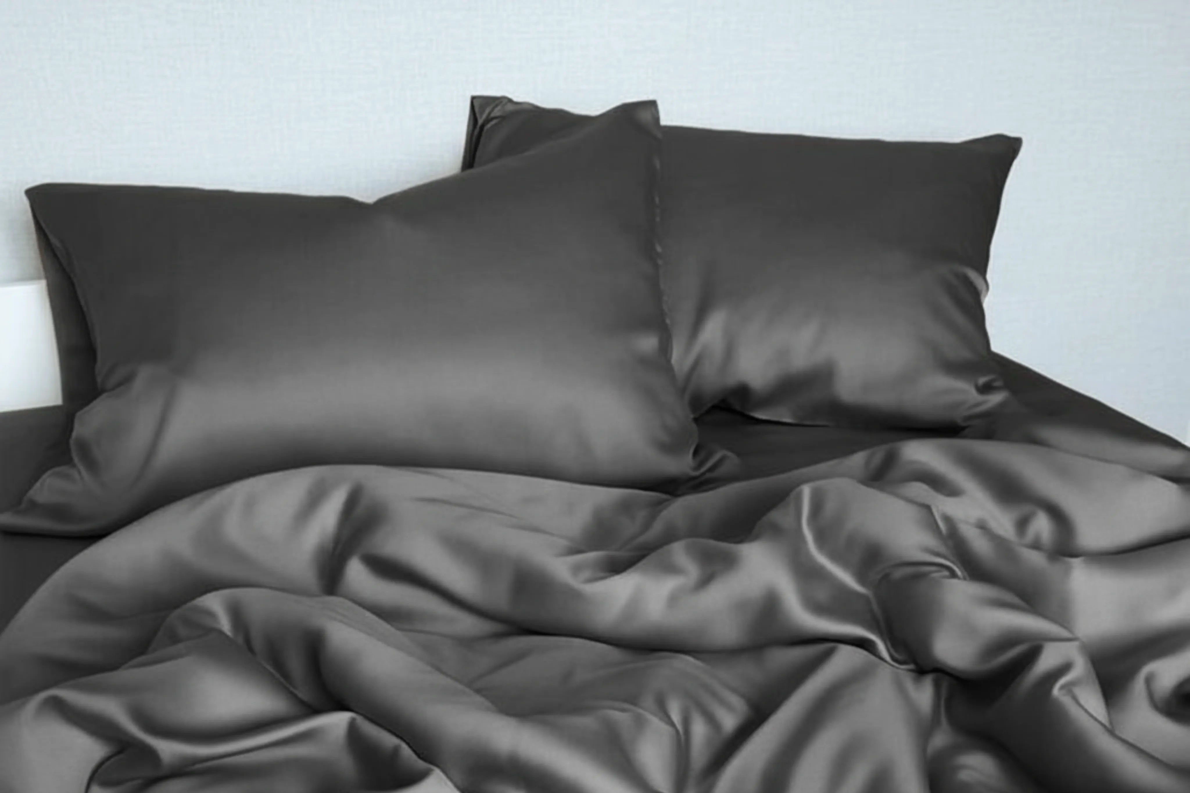 Dark grey satin bedding set with silky smooth pillow covers and sheets.