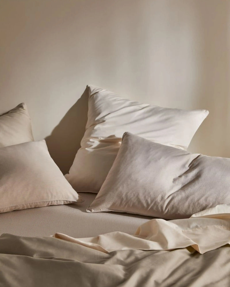 Luxury hotel bed with soft white pillows and premium bedding linen