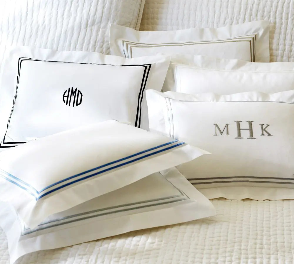 Luxury white monogram pillow covers with embroidered border detail