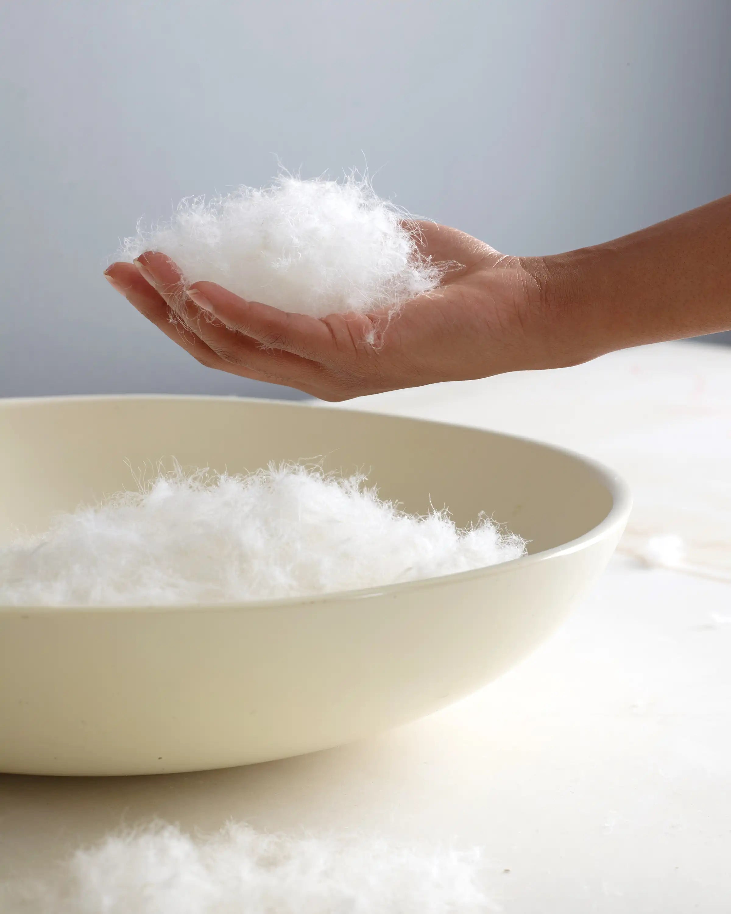 Soft microfiber pillow filling material held in hand