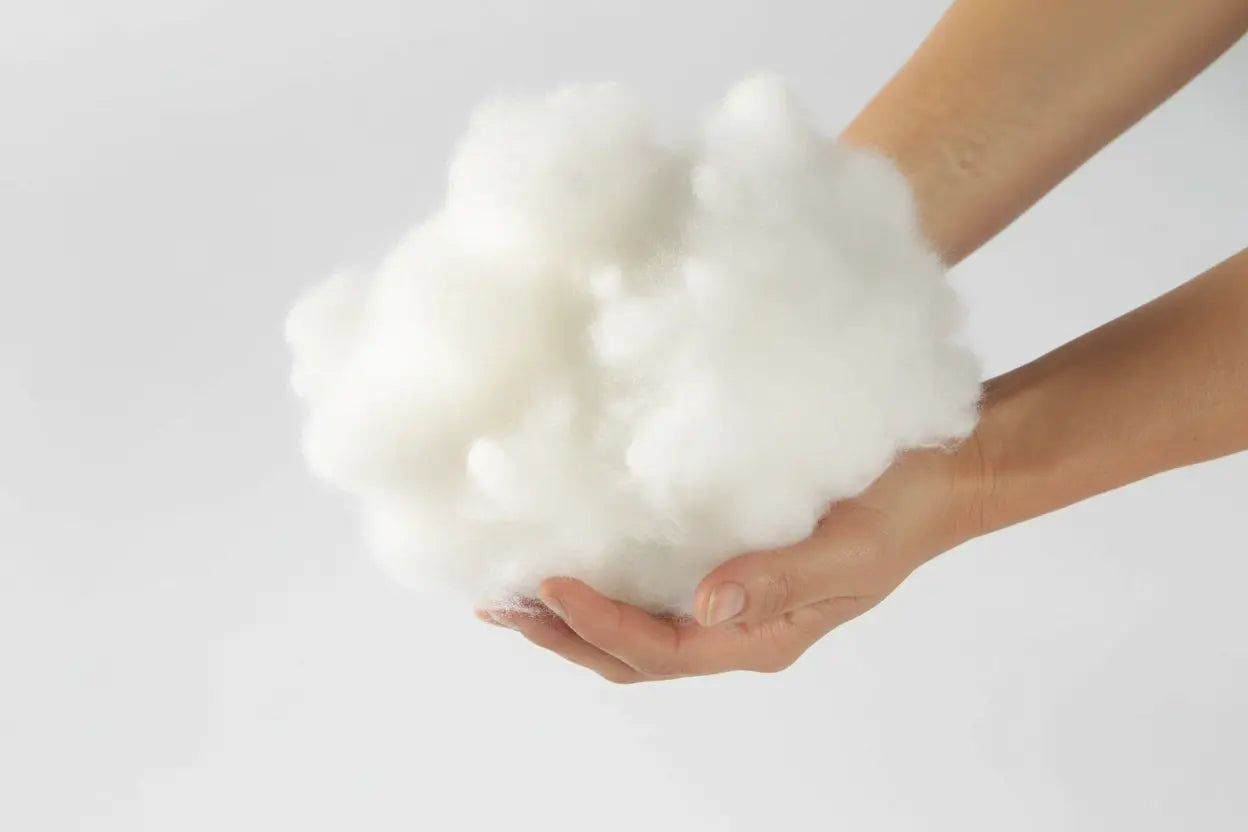 Soft polyester microfiber pillow filling material held in hands