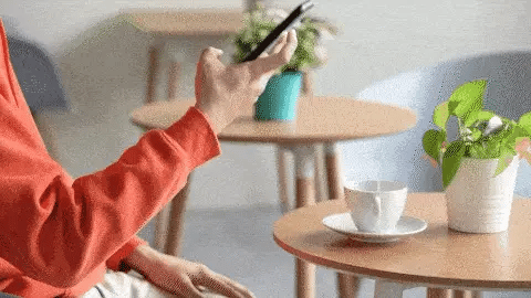 Person controlling smart home appliances using mobile phone app