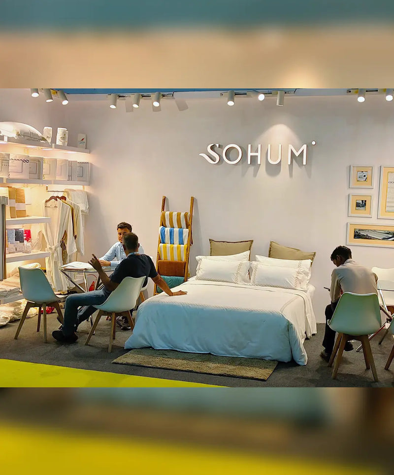 SOHUM luxury bedding and hotel linen products displayed at a home textile trade exhibition booth