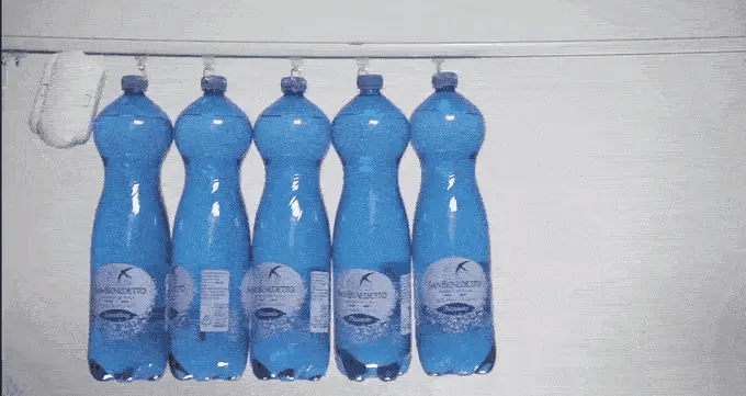 SwitchBot Curtain load capacity test with multiple water bottles hanging on curtain rod