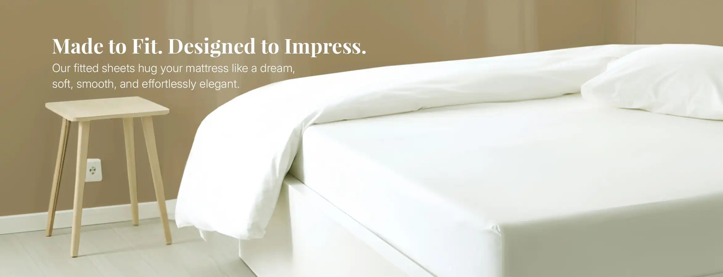 White fitted sheet neatly covering mattress in a minimal bedroom setting.