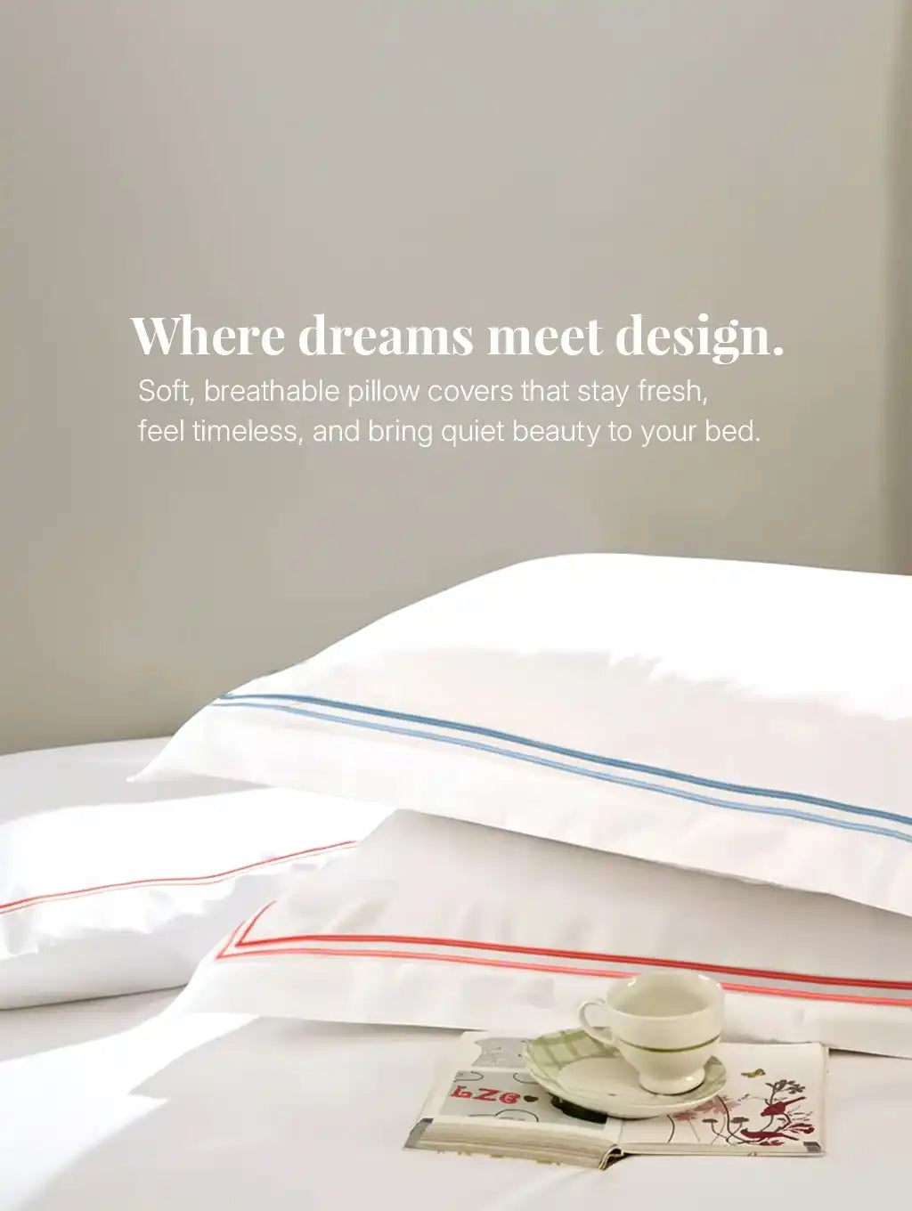 White pillow covers with blue and red border detailing on bed